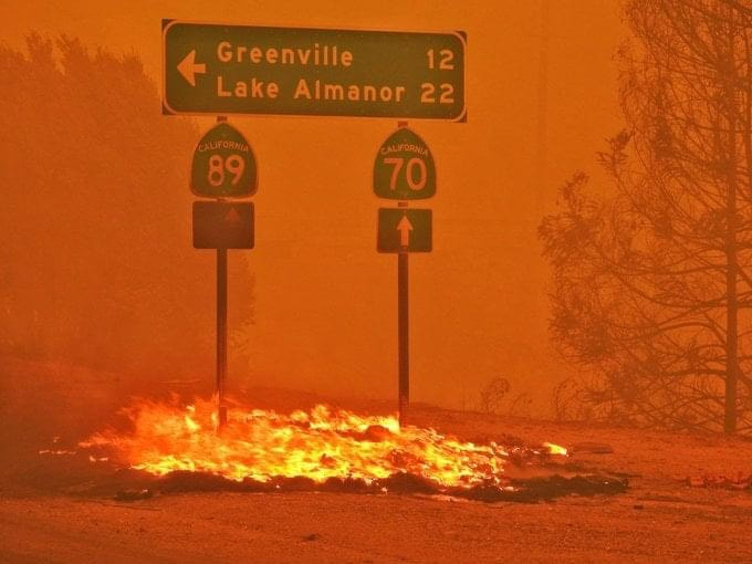 Highway sign for Greenville and Lake Almanor on fire