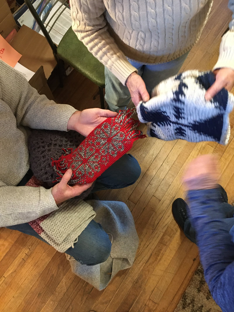 Many hands sharing their knitted items
